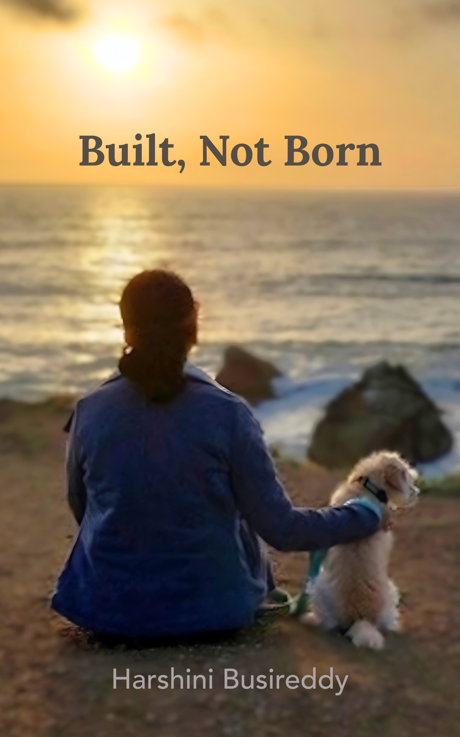 Book cover for Built, Not Born by Harshini Busireddy, showing Harshini seated with a dog at the ocean during sunset.